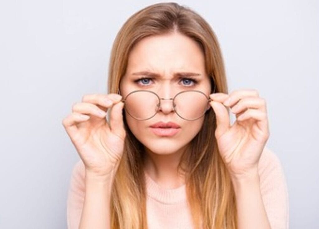Woman trying pair of glasses
